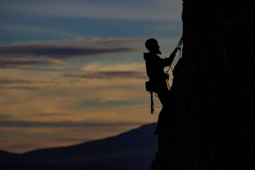 silhouetted climber at dusk