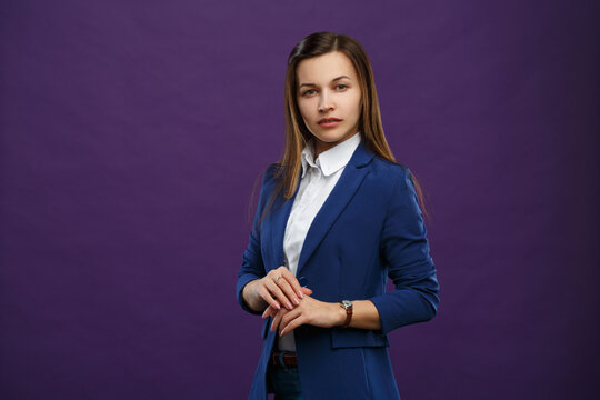 Business Elegant Woman In A Blue Suit On A Dark Purple Background.