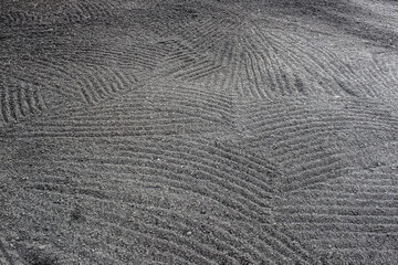Close-up of rake marks across farm field or lawn