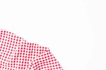 Top view tablecloth checkers picnic for the weekend. Fabric checkers cloth red and white square grid on a white background top view with copy space.