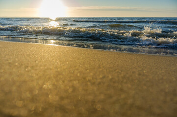Sunset over the sea. Red and yellow sky in the rays of the sunset. Reflection of sunlight in the sea waves.