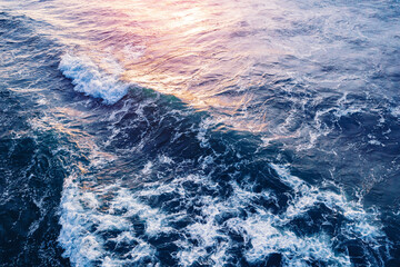 Waves in ocean splashing blue clean sea water sunset, Aerial top view