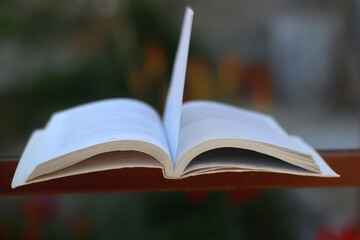 Open book in a garden. Selective focus.