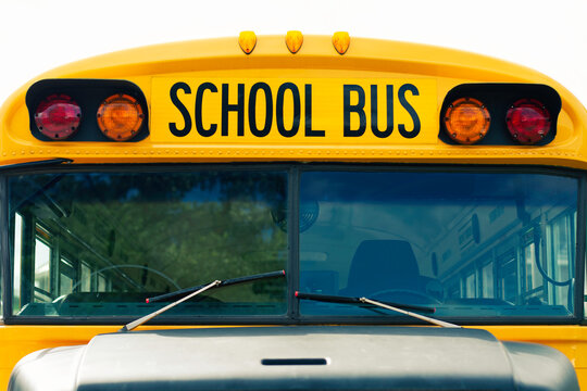 Front view of an ionic traditional bright yellow school bus