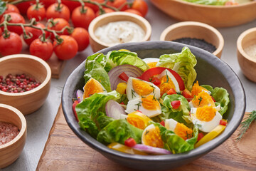 Diet menu. Healthy salad of fresh vegetables - tomatoes, egg, Onion. high angle view of a nutritious vegetable salad with boiled egg slices, served.  Healthy meal concept.