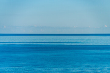 Fototapeta na wymiar Plain blue sea and sky for background, copy space 