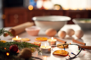 Baking christmas biscuits at home. Different ingredients for baking on the table with christmas decorations on the foreground