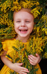 little girl with mimosa flowers