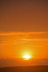 Sunset sun on the horizon with clouds in the evening