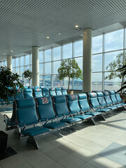 Empty airport lounge during COVID 19. Row of blue chairs