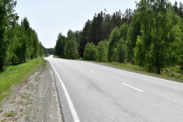 Fototapeta na wymiar High speed asphalt road highway in the afternoon in the forest