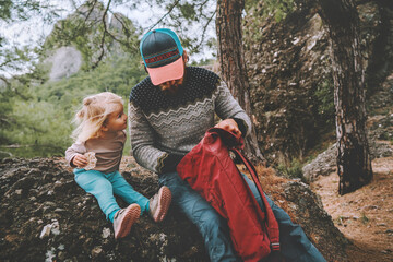 Family father and daughter child in forest travel with backpack camping picnic outdoor active...
