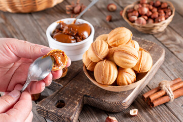 Fototapeta na wymiar Homemade Russian nuts with condensed milk. Cut nuts with condensed milk on table