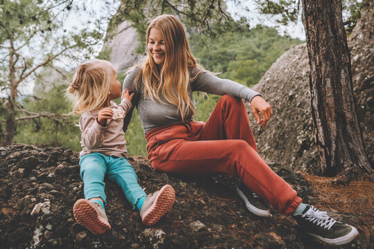 Mother and daughter child outdoor family lifestyle summer vacations together walking in forest happy positive emotions mothers day