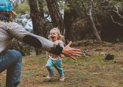 Laughing Child Running To Father Family Walking Together In Forest Lifestyle Positive Happy Emotions Daughter With Dad