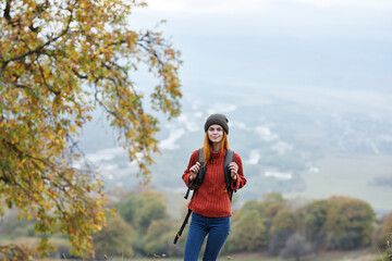 woman hiker travel in the mountains autumn trees vacation