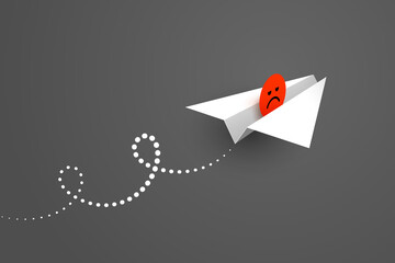 White paper airplane and red unhappy face icon over dark background - obrazy, fototapety, plakaty