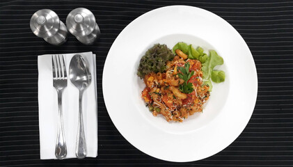 macaroni with chicken on black fabric