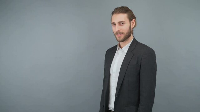 Handsome man in a checkered shirt isolated on gray background showing ok sign