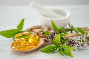 Alternative medicine herbal organic capsule with vitamin E omega 3 fish oil, mineral, drug with herbs leaf natural supplements for healthy good life.
