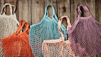 Fototapeta premium Multicolored eco mesh bags. Biodegradable, reusable alternative to plastic bags. Zero waste concept