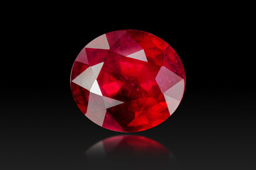 Natural treated red ruby oval faceted precious gemstone setting isolated on black background. Front view, bottom semireflection, blur. Closeup macro details, veins, cracks, inclusions, facets