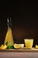 Limoncello. Lemon alcoholic beverage. Shot glass of Italian lemon liqueur, fresh lemons and...