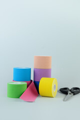 Rolls kinesiology tape for athletes and scissors. Body correction and acceleration of lymph outflow. Kinesiology taping manipulate nerve receptors and reduces pain in muscles and speeds up the healing