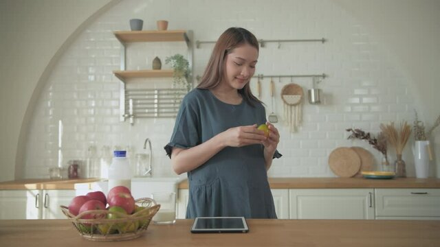 Pregnant woman concept of 4k Resolution. Young women choosing to eat fruit in the kitchen.