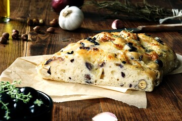 Homemade Italian Focaccia with mozzarella, hazelnut, red onion, black olive, garlic , rosemary and thyme
