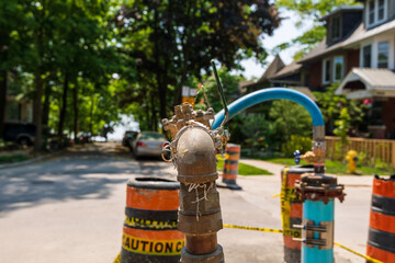 Fototapeta na wymiar Pipes and fixtures used in a project to replace and upgrade the basic dringking water infastructure in an older Toronto neighbourhood.
