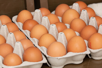 Uma bandeja com ovos de galinha marrom e orgânica repousa sobre a mesa, destacando sua frescura e naturalidade.