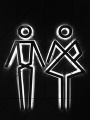Image of a male and female sign in the form of little men on a black background for the toilet room. WC.