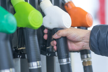 Fuel pump nozzles for different kinds of fuel in a filling station