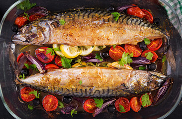 Baked mackerel with herbs and lemon and  vegetables. Healthy dinner. Top view, flat lay
