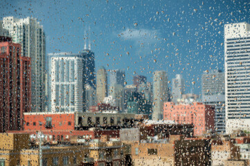 Downtown Chicago skyscrapers through a rainy window.