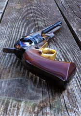 Black powder revolver on an old board.