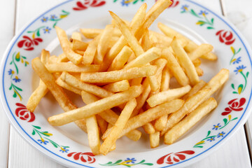 golden french fries on the wooden background