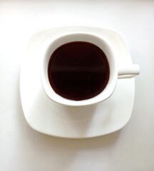 White cup with black coffee. Flat lay