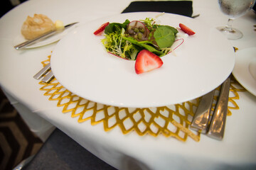 Salad bowl with spinach strawberries pumpkin seeds and dressing