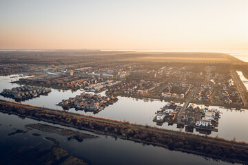 Modern residential neighborhood in Almere, Flevoland, The Netherlands, featuring artificial islands, surrounded by water. Aerial view. 