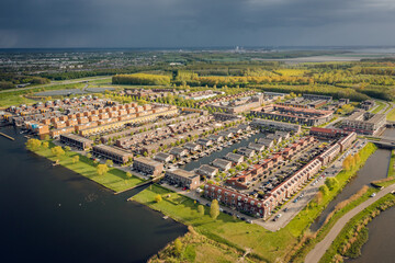 Modern residential neighborhood in Almere, Flevoland, The Netherlands, surrounded by nature. Aerial view. 
