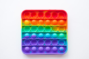 Antistress pop it toy. Rainbow sensory fidget isolated on white background. New trendy silicone toy.