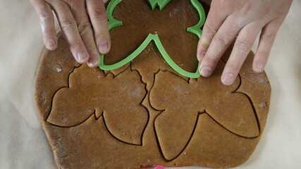 The rolled-out gingerbread dough is on the table. Butterfly figure.