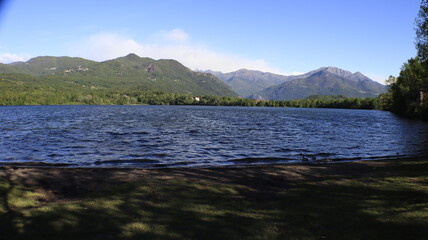 waves on a lake  with a beautiful green mountain landscape