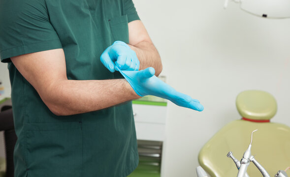 The Dentist Puts On Gloves