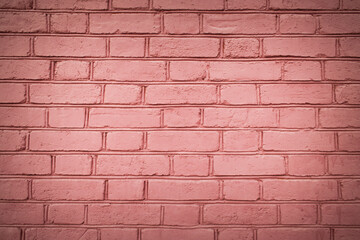 Texture of a pink brick wall laid with gray cement as a background