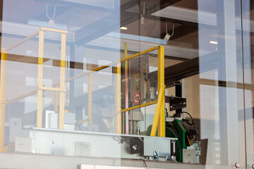 Mechanisms and details of the glass elevator at the airport. View through glass.
