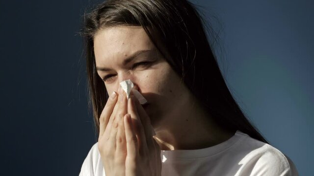 Portrait of a sick woman with symptoms of flu, cold or coronavirus.