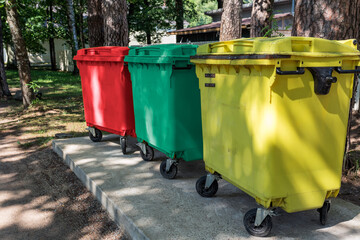 On the site there are multi-colored waste containers